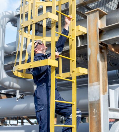 Factory engineer or technician worker climb up on stair of  petrochemical gas pipeline to work or maintenance in workplace.